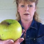 woman holds apple