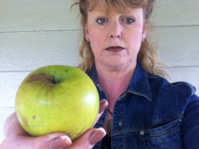 woman holds apple